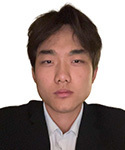 Young man with dark hair in a black suit and white shirt.